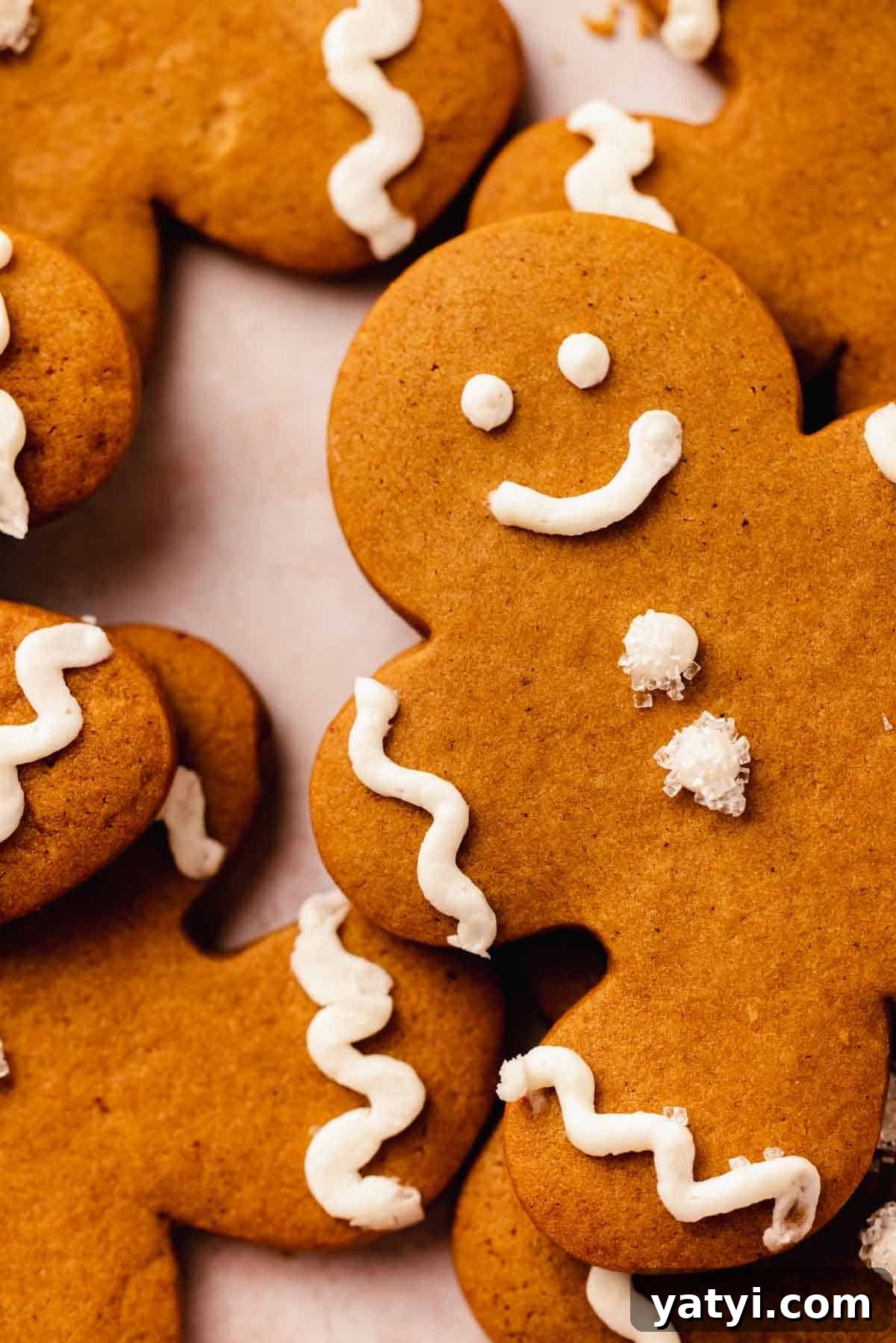 gingerbread man cookie closeup showing sparkly sugar on buttons and piped buttercream details