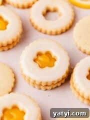 lemon curd filled cut out lemon shortbread cookies shaped like flowers