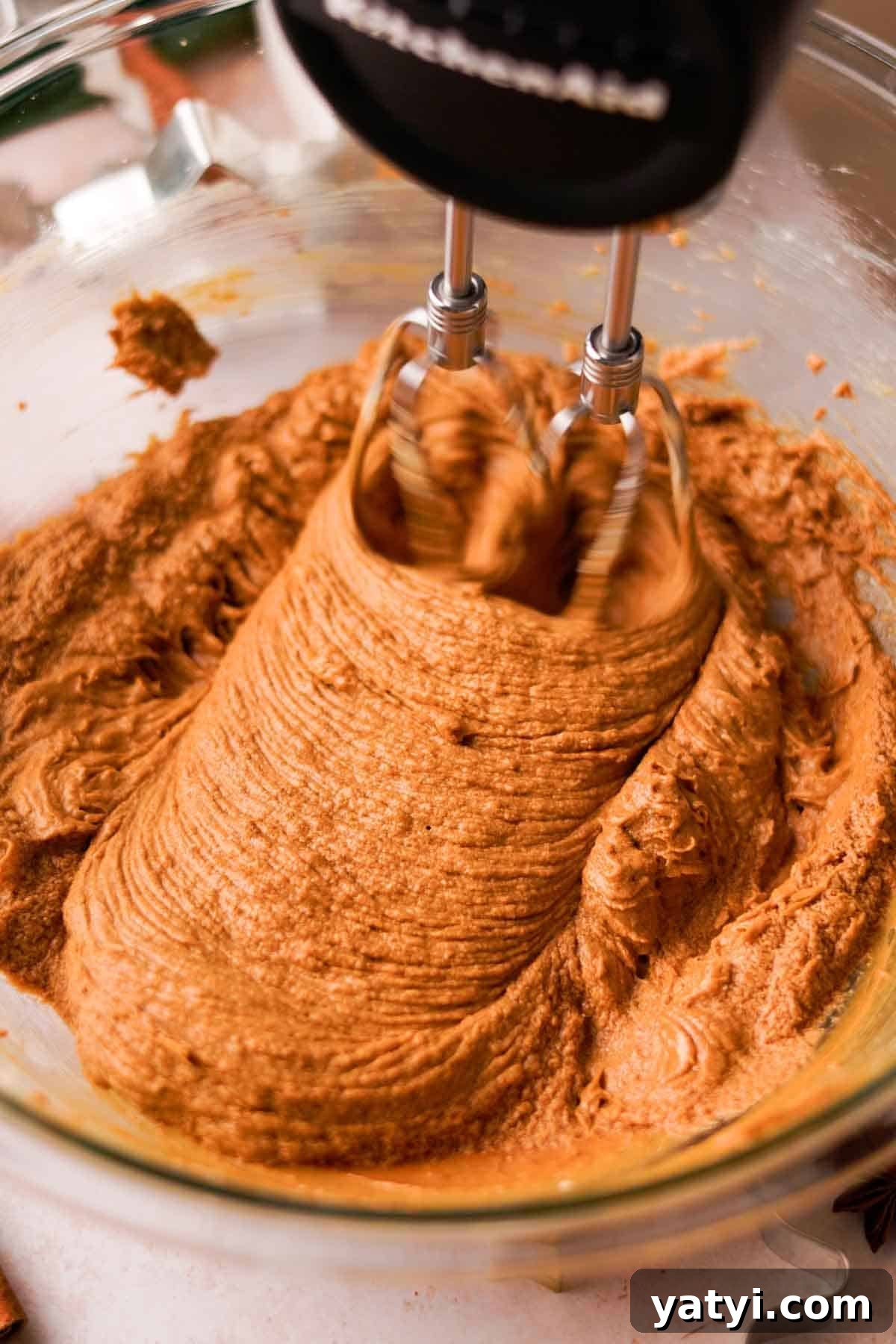 beating butter, sugar, egg, and molasses until smooth and fluffy for gingerbread cookie dough