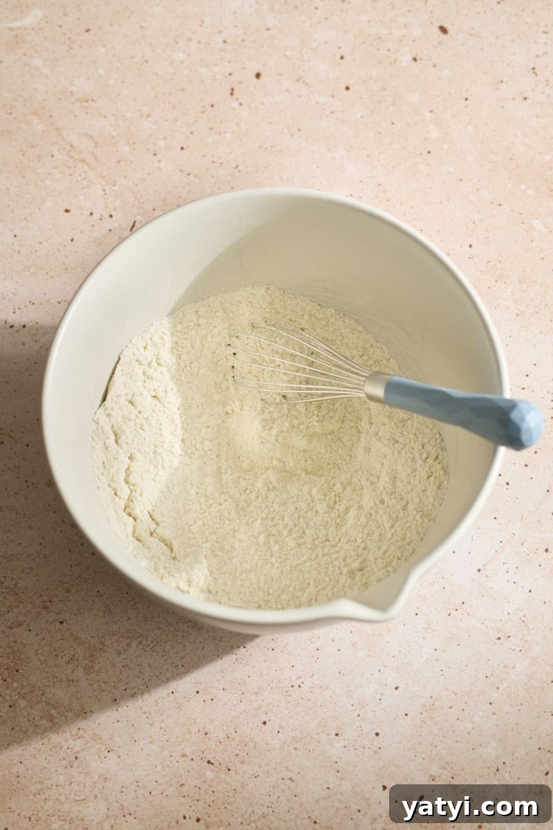 Sourdough Discard Scone Recipe: Flaky Base for Sweet or Savory Add-Ins 5 Dry ingredients mixed in a white bowl.