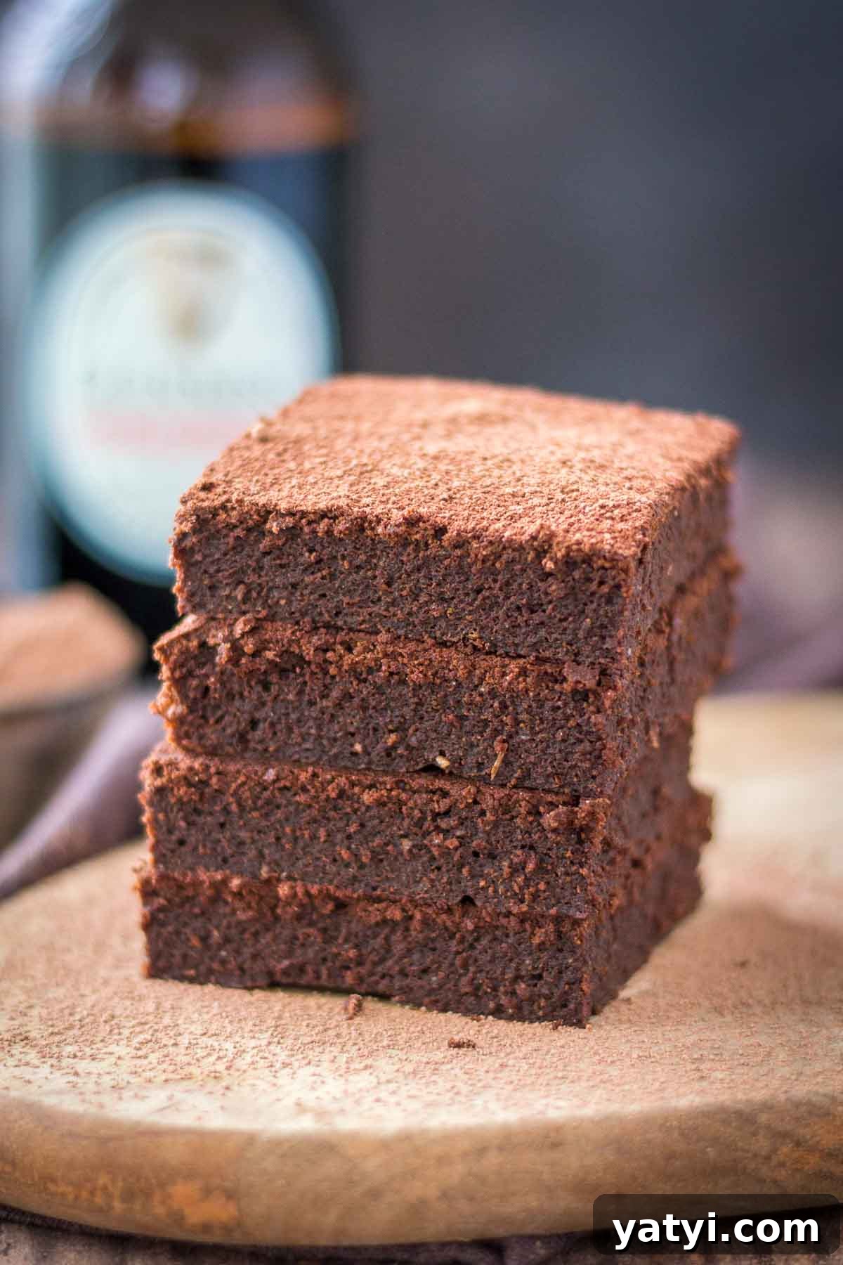 Guinness Chocolate Brownies with Rich Stout Flavor 4 Chocolate Guinness Brownies served on a wooden plate