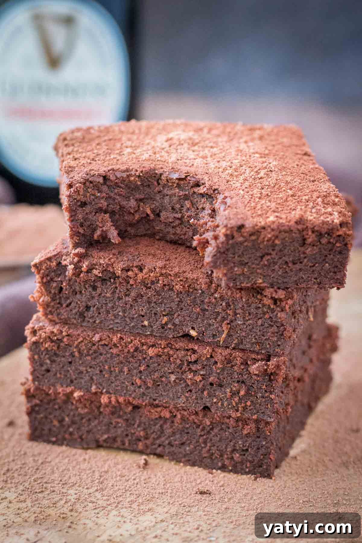 Guinness Chocolate Brownies with Rich Stout Flavor 6 Chocolate Guinness Brownies served on a wooden plate