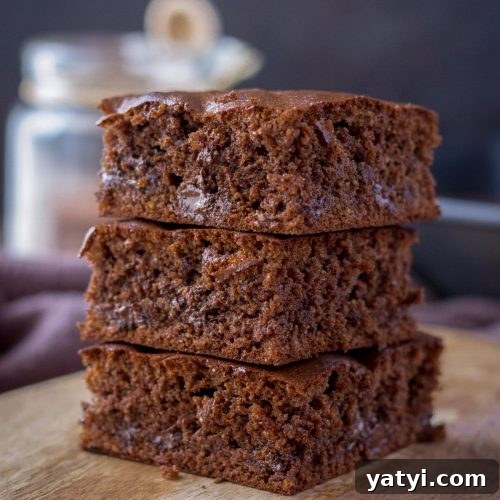 Almond butter brownies sliced and served on a wooden plate