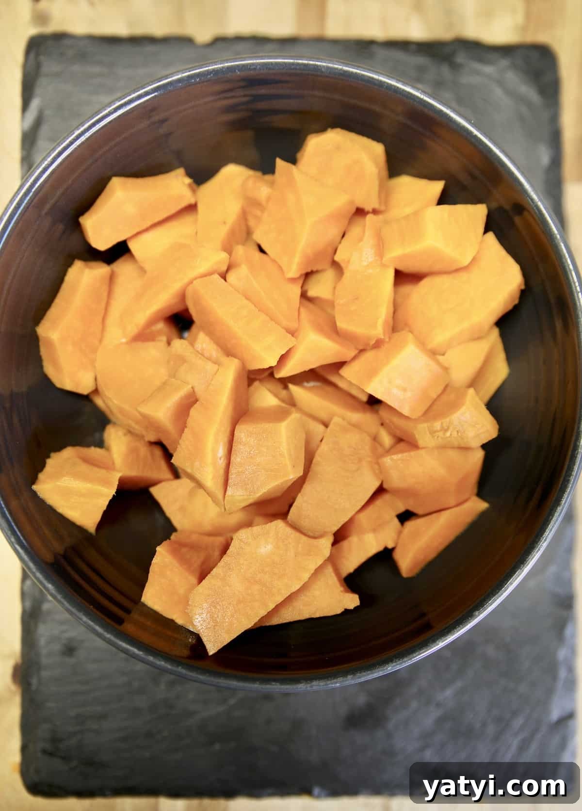 How to make sweet potato casserole without marshmallows. Bowl of diced sweet potatoes.