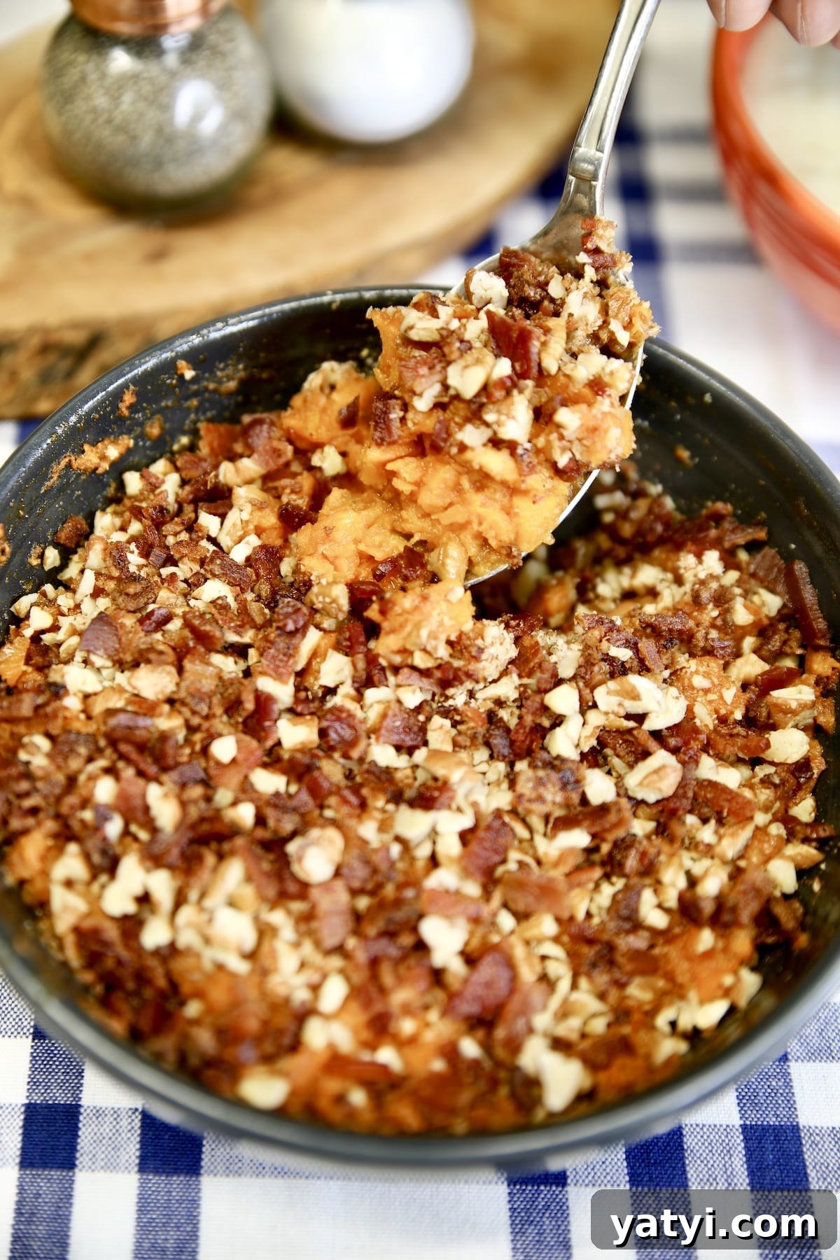 Bacon and pecan sweet potato casserole - easy grilling recipe. Spoon of sweet potato casserole.