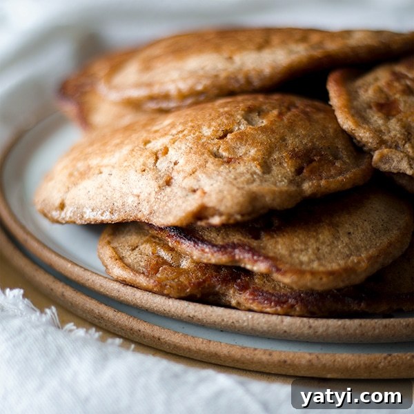 Buttermilk Apple Cinnamon Pancakes with Brown Sugar Glaze 3 A plate of Apple Cinnamon Pancakes made with buttermilk and applesauce.