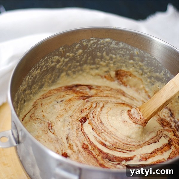 Buttermilk Apple Cinnamon Pancakes with Brown Sugar Glaze 6 Stirring apples and brown sugar into apple cinnamon pancake batter.