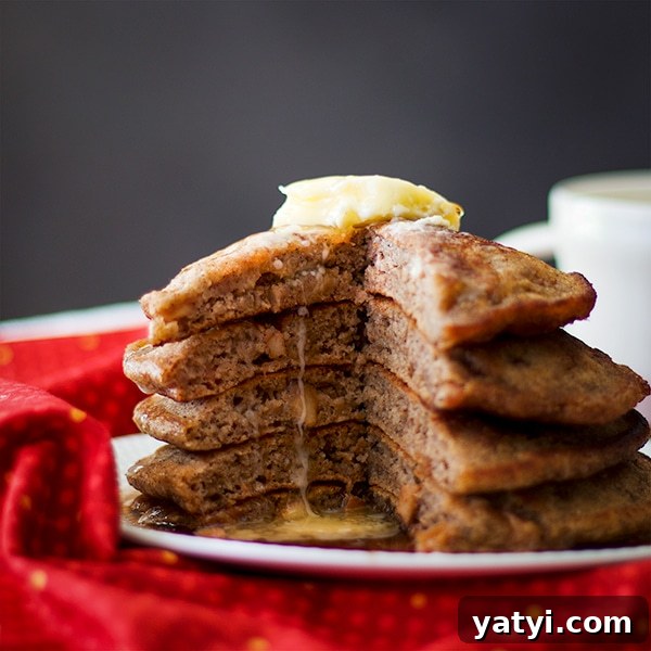 Buttermilk Apple Cinnamon Pancakes with Brown Sugar Glaze 7 A stack of Apple Cinnamon Pancakes with butter.