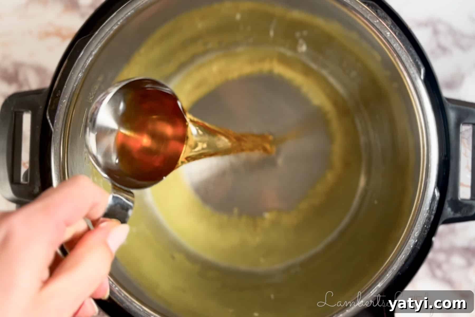 pouring apple cider vinegar in an instant pot.