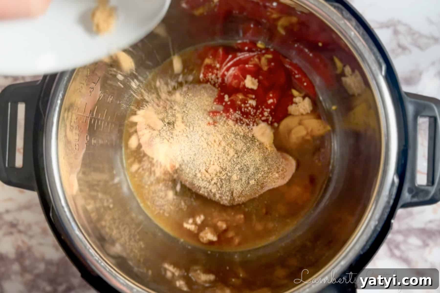 covering a chicken breast in an instant pot with brown sugar and seasonings.
