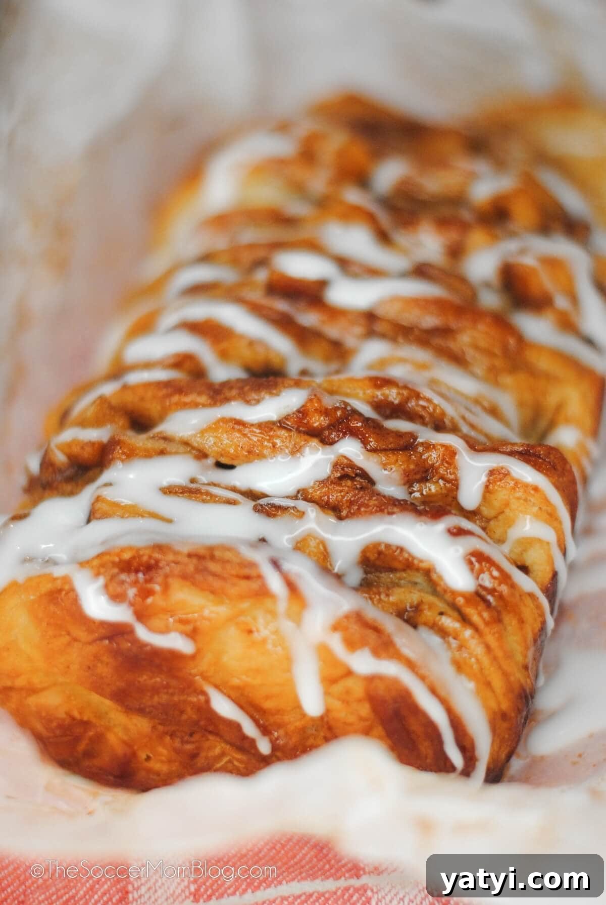 Cinnamon Apple Pull-Apart Bread Recipe 2 loaf of glazed apple bread on parchment paper.