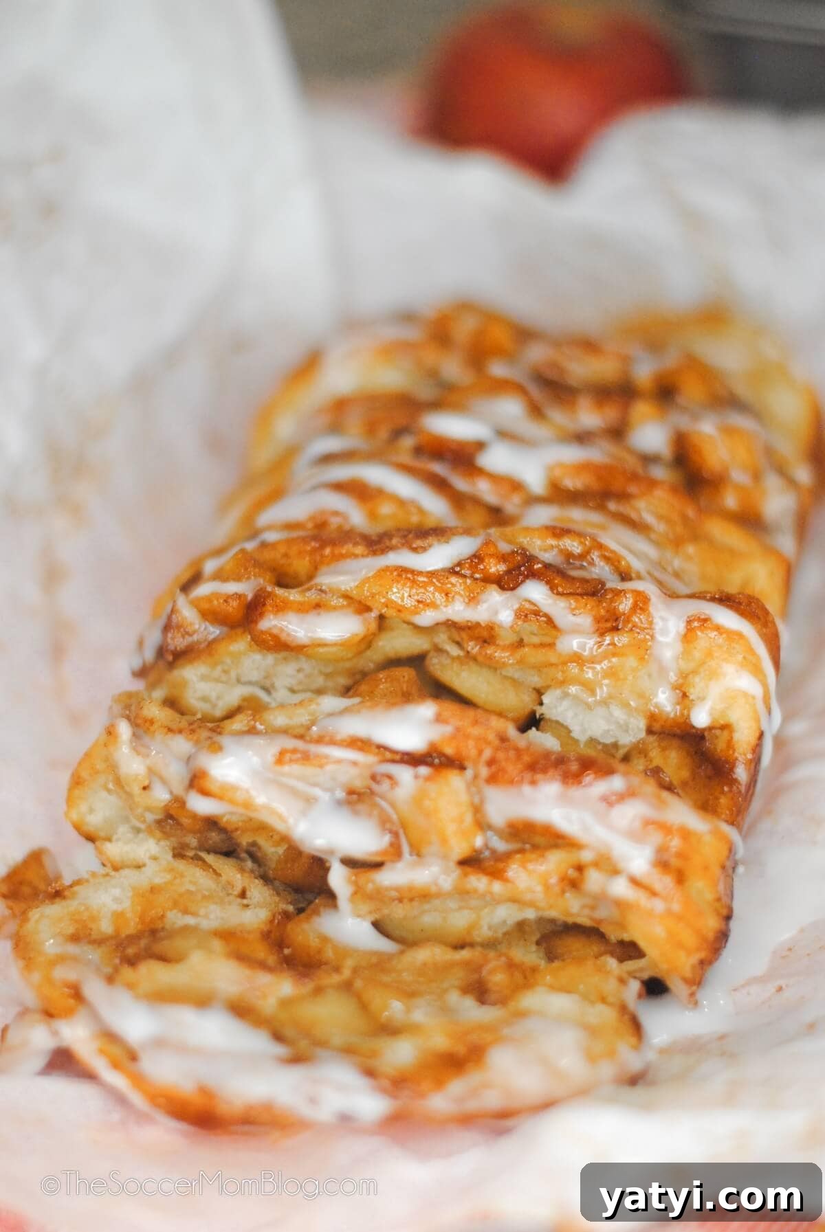 Cinnamon Apple Pull-Apart Bread Recipe 4 loaf of apple pie pull apart bread with apple in background.