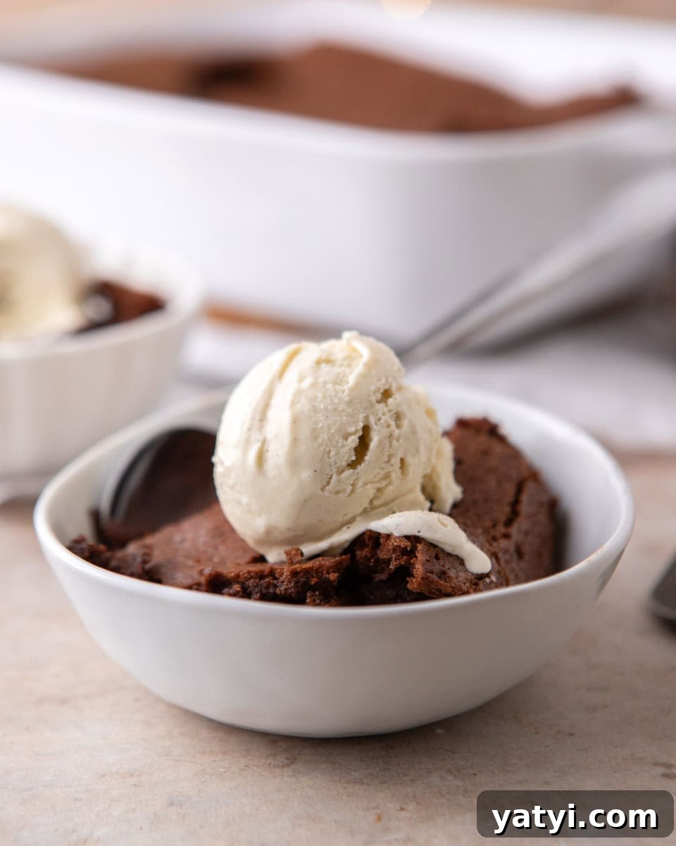 Ina Garten’s Brownie Pudding Recipe That’s Gone Viral 2 Brownie pudding served warm with vanilla ice cream in a white bowl