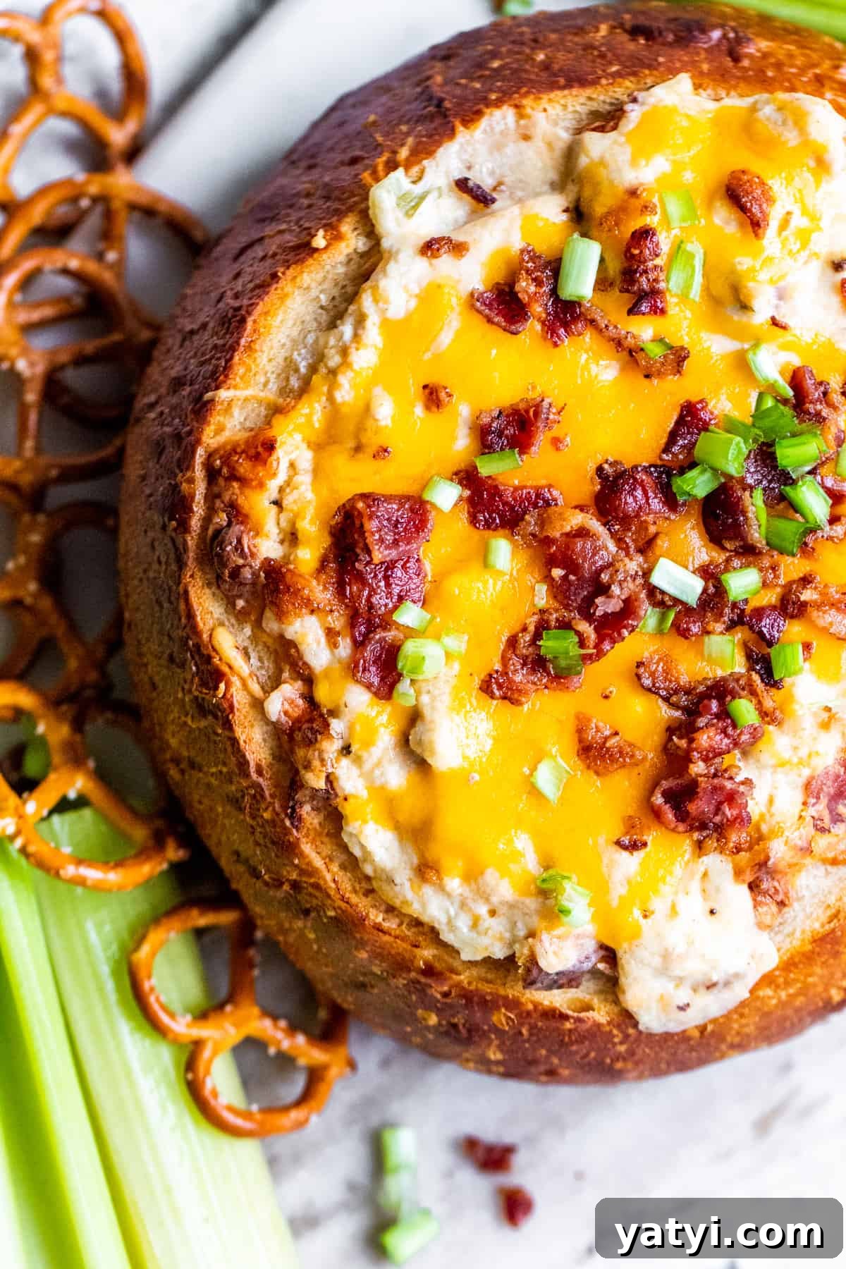 Baked Bacon and Cheese Dip Served in a Warm Bread Bowl 5 Overhead shot of dip with dippers on side.