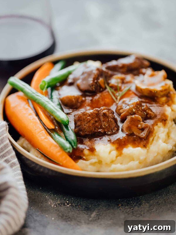 Creamy Garlic Mashed Potatoes in the Instant Pot (Pressure Cooker) 11 Pressure Cooker Beef Bourguignon served with mashed potatoes and grilled veggies in a black plate.