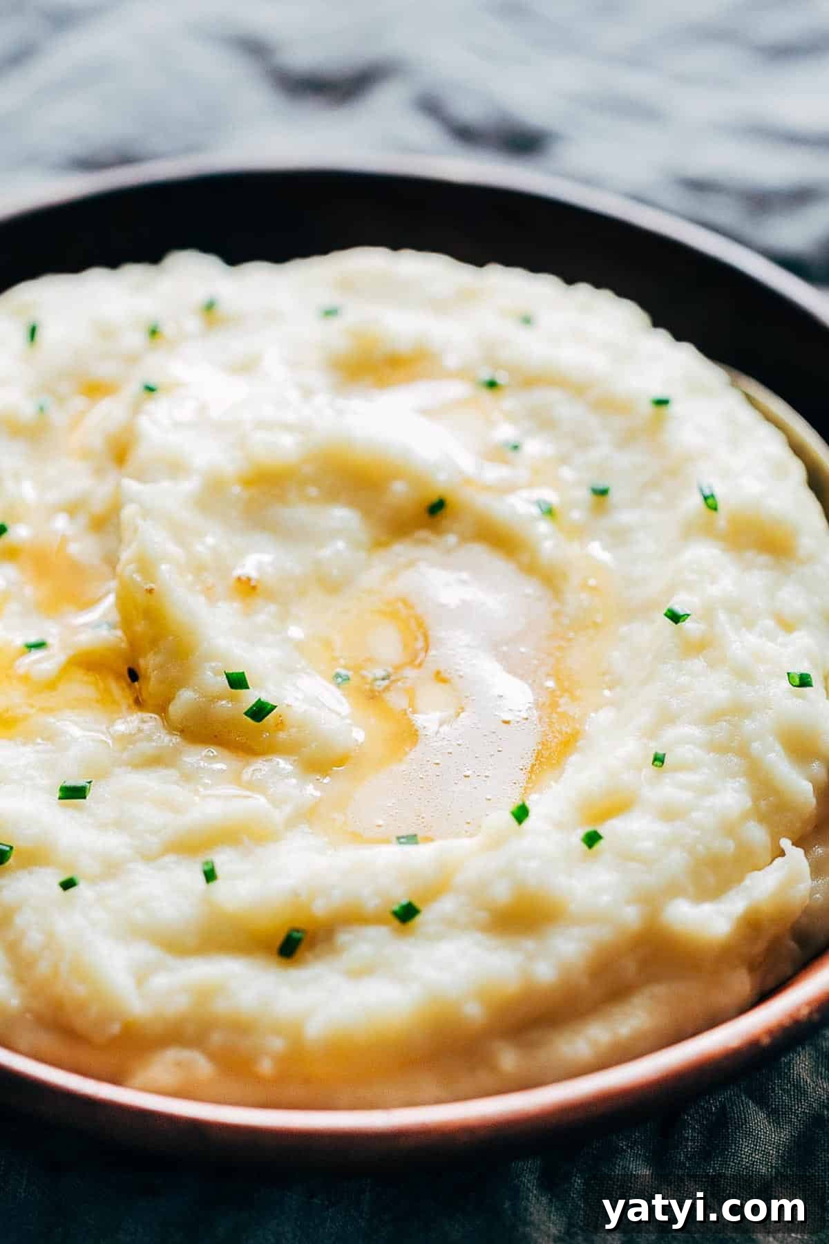 Creamy Garlic Mashed Potatoes in the Instant Pot (Pressure Cooker) 7 Mashed potatoes flavored with garlic and served in a wooden bowl.