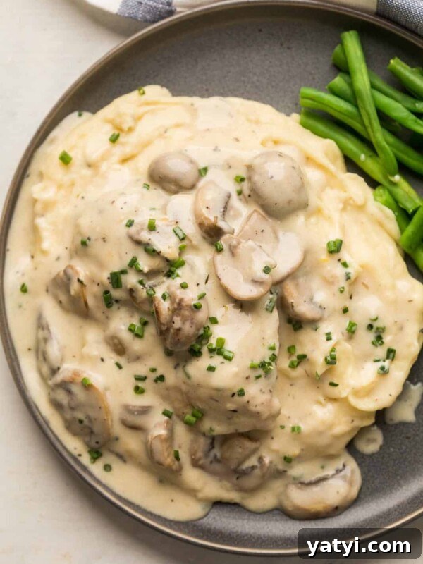 Creamy Garlic Mashed Potatoes in the Instant Pot (Pressure Cooker) 9 Instant Pot Chicken in mushroom sauce served over a bed of mashed potatoes on a grey plate with steamed green beans