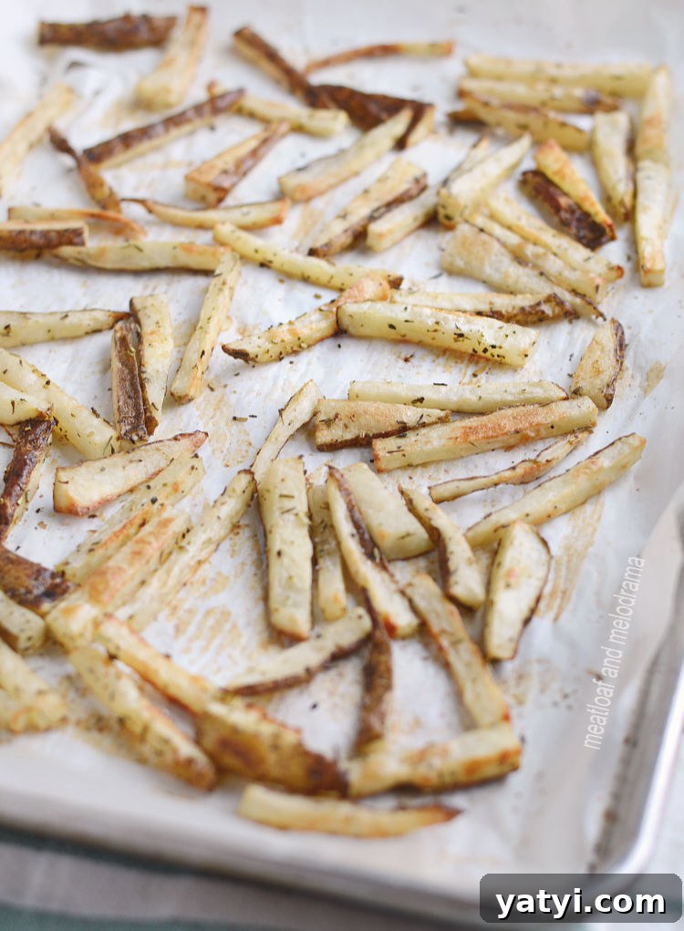 Crispy Oven-Baked French Fries You Can Make at Home 4 homemade baked french fries on parchment baking sheet