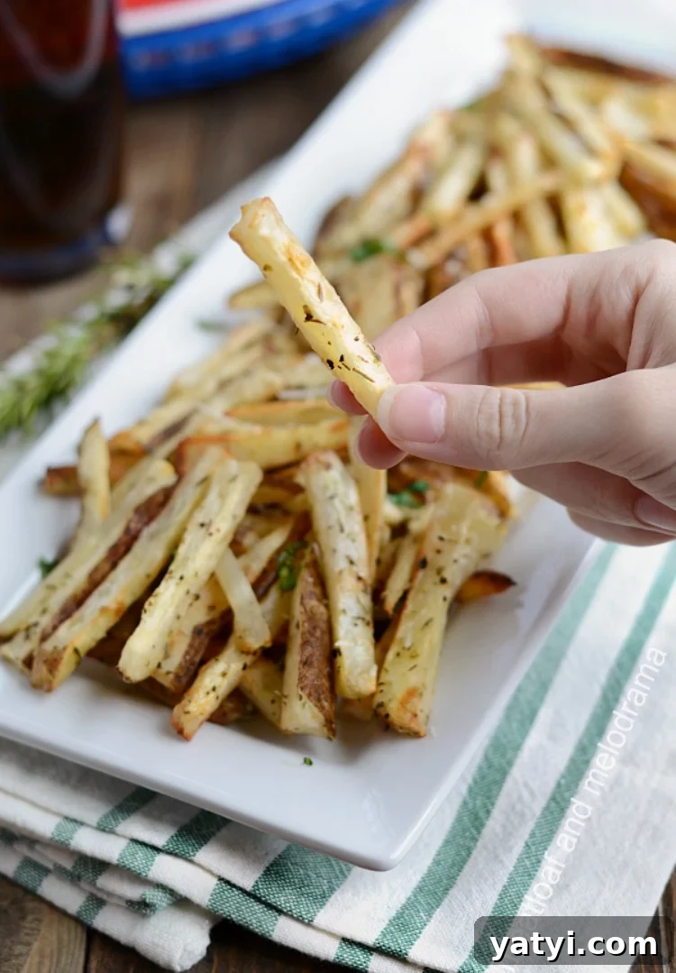 Crispy Oven-Baked French Fries You Can Make at Home 5 homemade baked french fries in hand