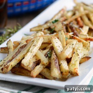 homemade baked french fries with rosemary on white platter