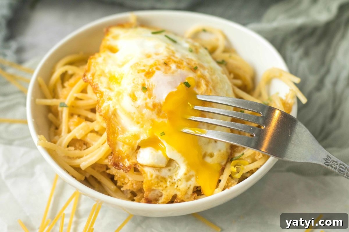 oozing egg yolk of a fried egg over pasta pangrattato