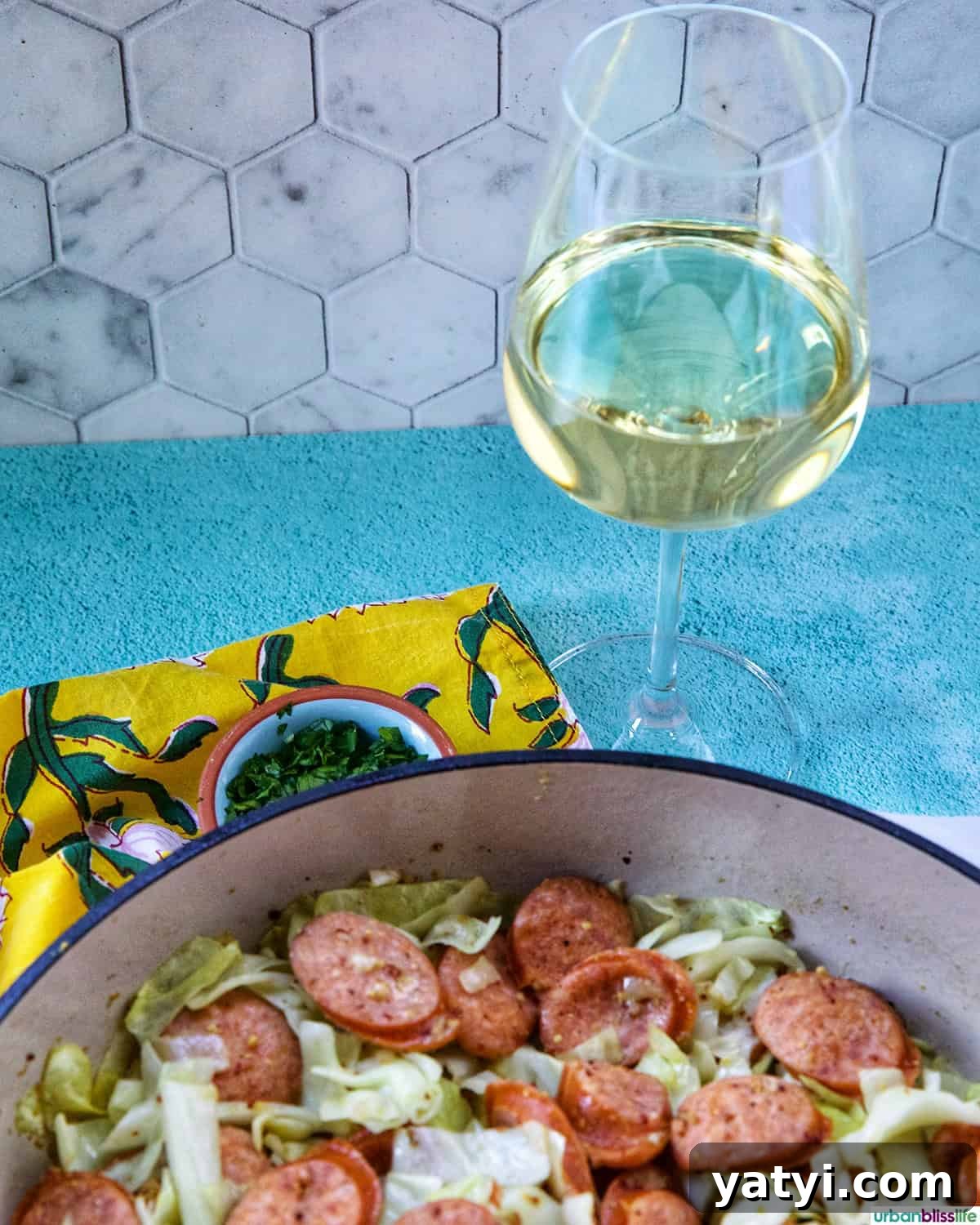 Savory Sausage and Cabbage Skillet Recipe for Weeknight Dinners 13 Glass of white wine with Sausage and Cabbage skillet.