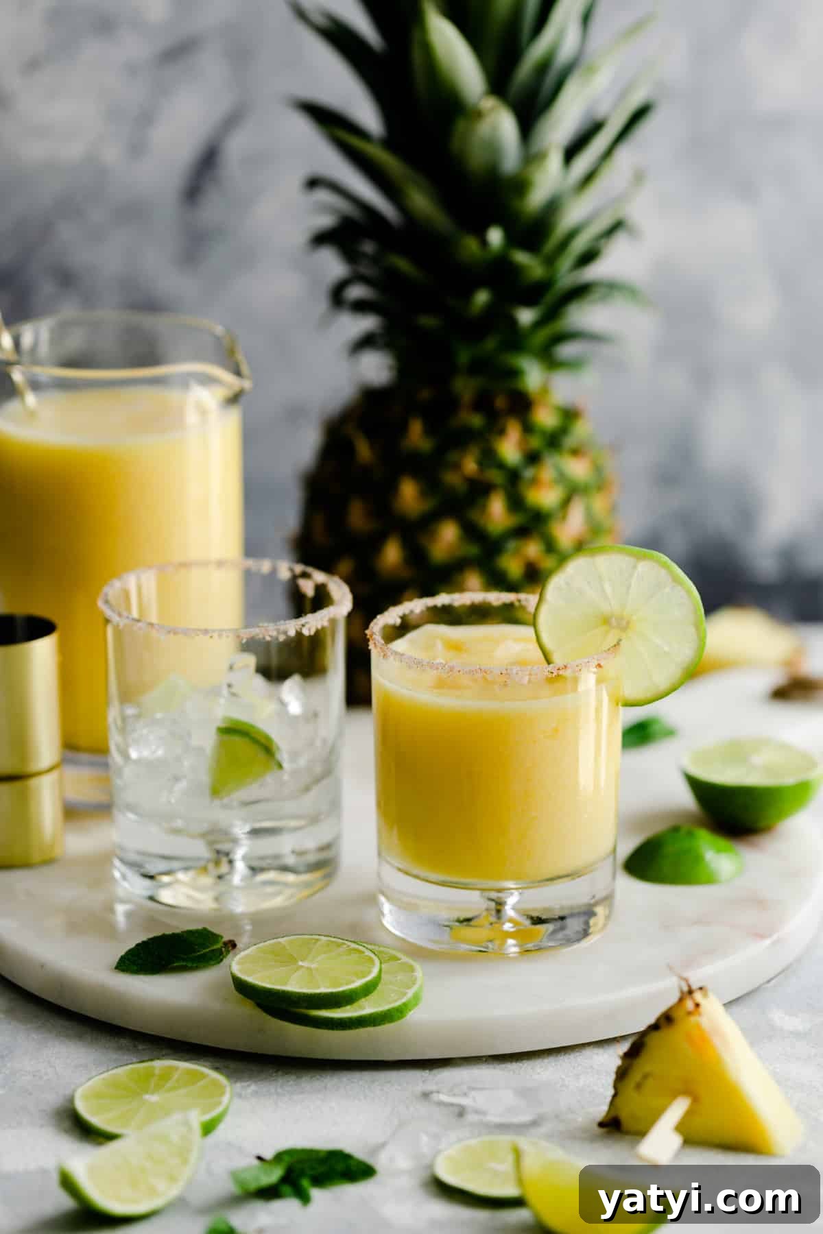 Frozen Pineapple Margarita Recipe — Tropical Cocktail Guide 6 short glass with frozen cocktail on a marble board