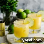 Frozen Pineapple Margarita Recipe — Tropical Cocktail Guide 10 two glasses filled with pineapple margarita cocktail