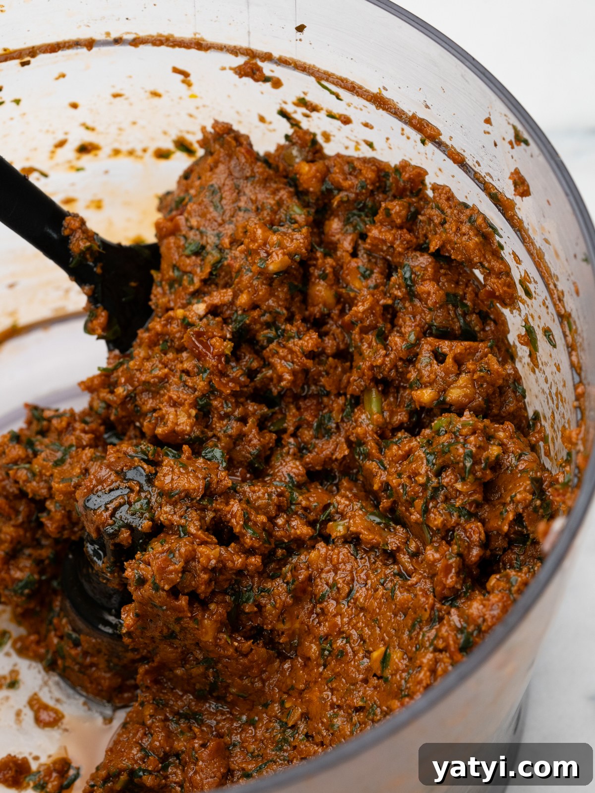 Sun-Dried Tomato Pesto (Pesto Rosso) Recipe & Uses 3 Close up of sundried tomaote pesto in food processor.