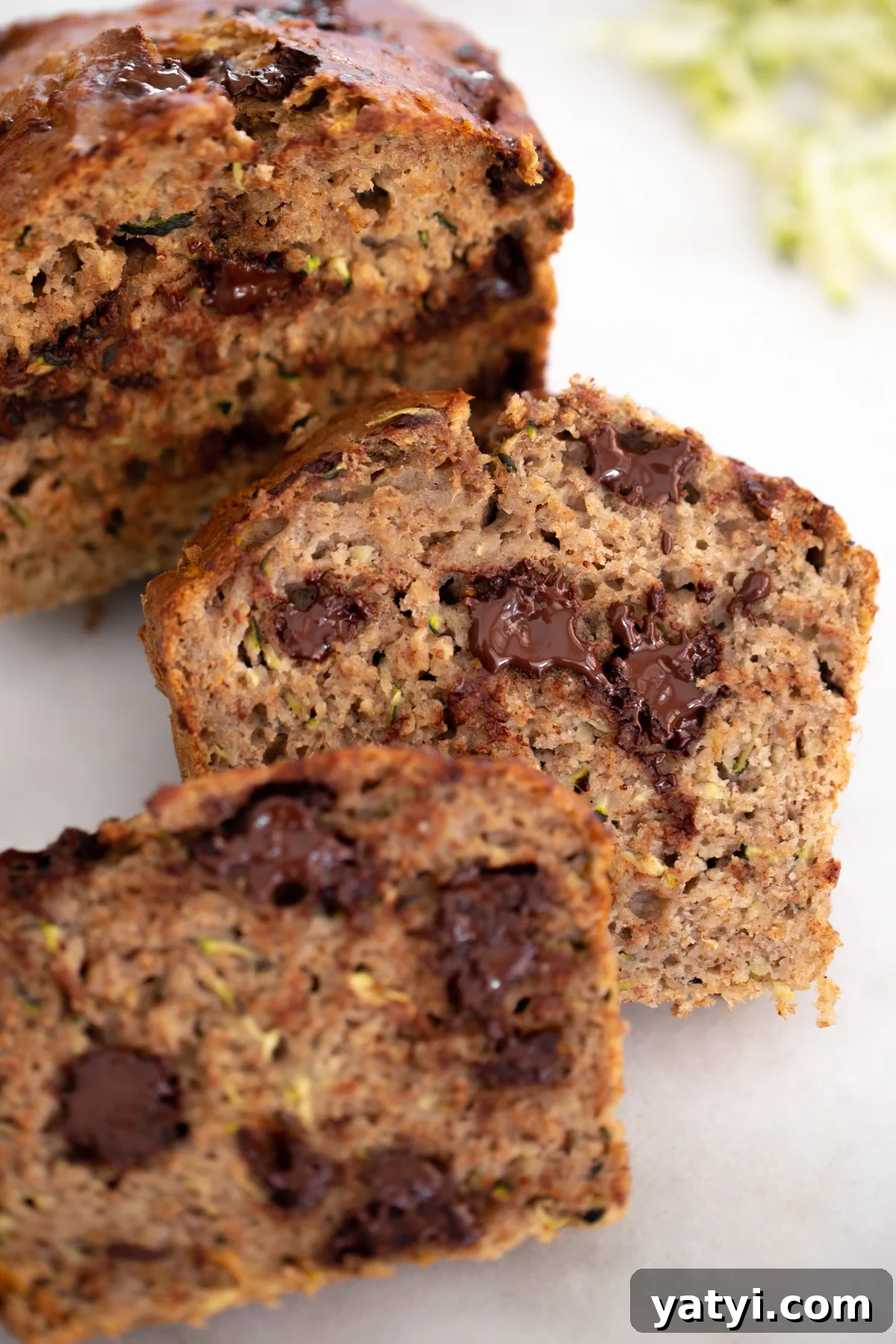 No-Added-Sugar Zucchini Banana Bread Recipe for Moist Loaves 5 Closeup photo of sliced healthy zucchini banana bread with melted chocolate chips