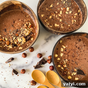 Chocolate Hazelnut Smoothie Bowl: Creamy Breakfast Recipe 7 Close-up top down view of three bowls of chocolate smoothies topped with crushed hazelnuts.