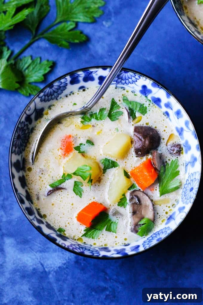 Polish Mushroom Soup with Yukon Gold Potatoes Recipe 2 Polish Mushroom soup in a blue bowl with spoon