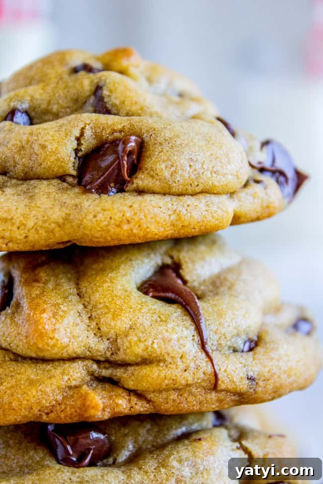 Brown Butter Chocolate Chip Cookies Recipe for Crispy Edges and Chewy Centers 7 a stack of chocolate chip cookies with melting chocolate chips.