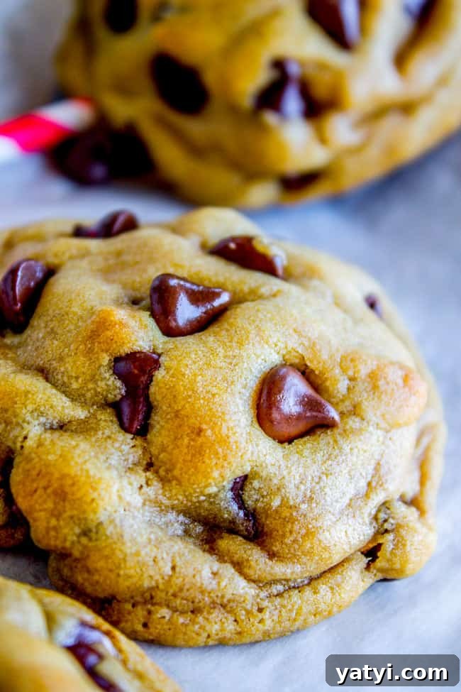 Brown Butter Chocolate Chip Cookies Recipe for Crispy Edges and Chewy Centers 8 chocolate chip cookies on parchment paper.