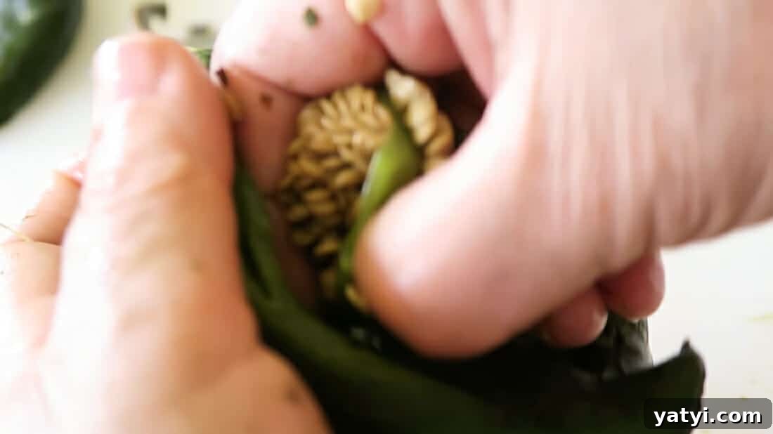 Authentic Chiles Rellenos: Mom’s Homemade Recipe with Video 11 removing the seeds from the peppers
