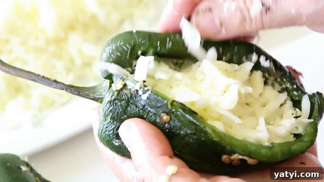 Authentic Chiles Rellenos: Mom’s Homemade Recipe with Video 12 stuffing the poblano peppers with cheese and onions