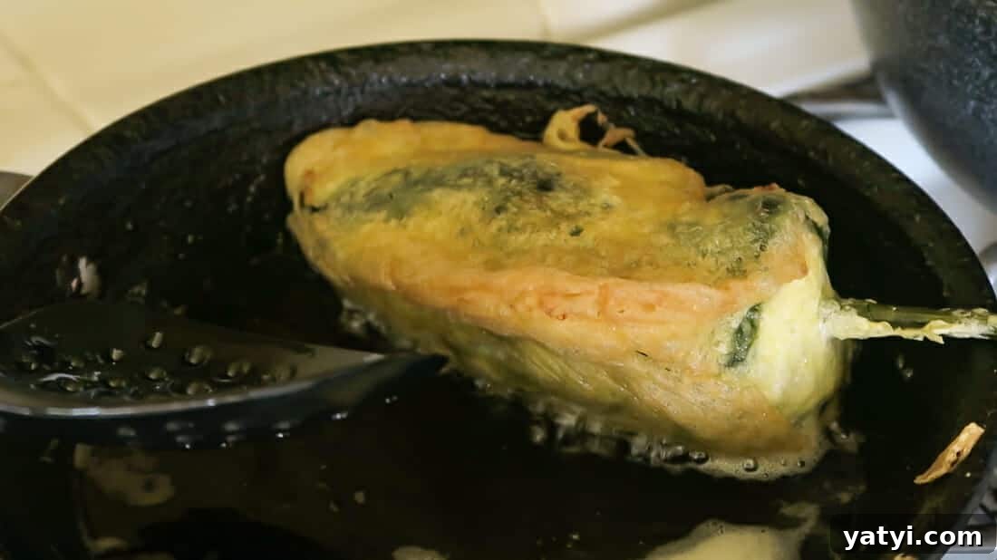 Authentic Chiles Rellenos: Mom’s Homemade Recipe with Video 16 frying the chiles rellenos