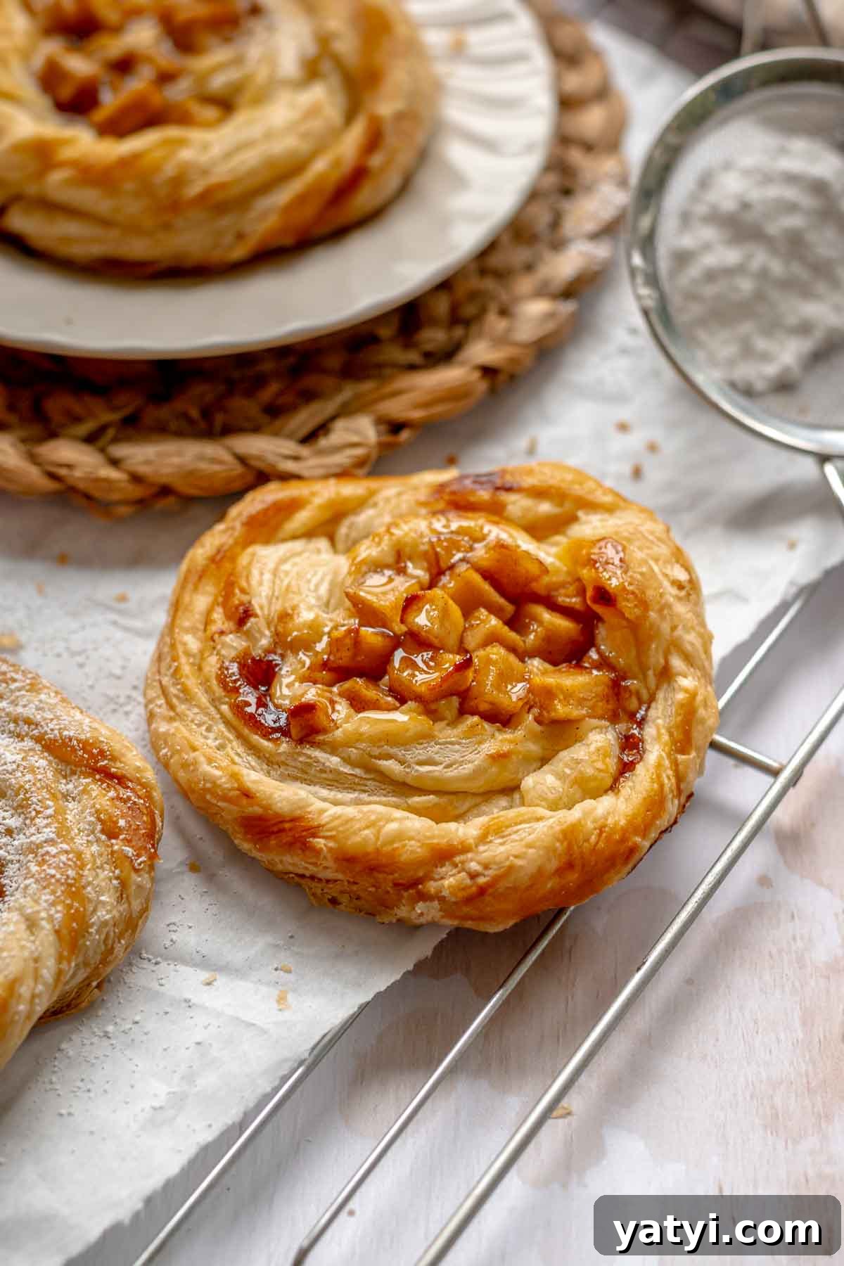Baked apple danish on a cooling rack.