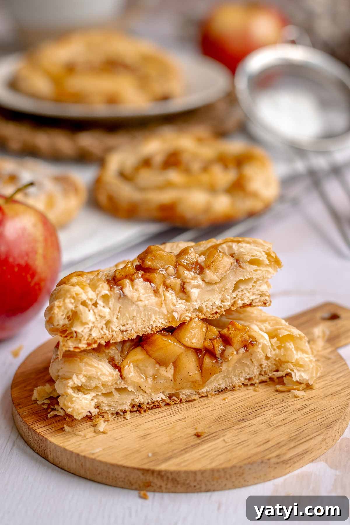 Apple danish cut in half and stacked on top of each other.