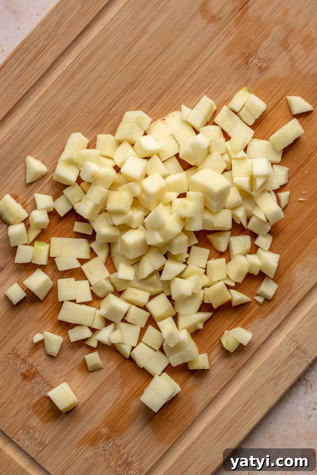 Diced apples on a cutting board.
