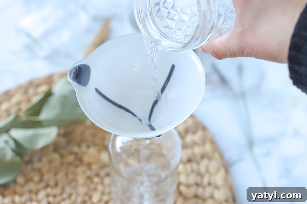 DIY All-Purpose Cleaner That Cleans Glass and Surfaces 3 funnel on a glass jar, and pouring vinegar in to make diy all purpose cleaner