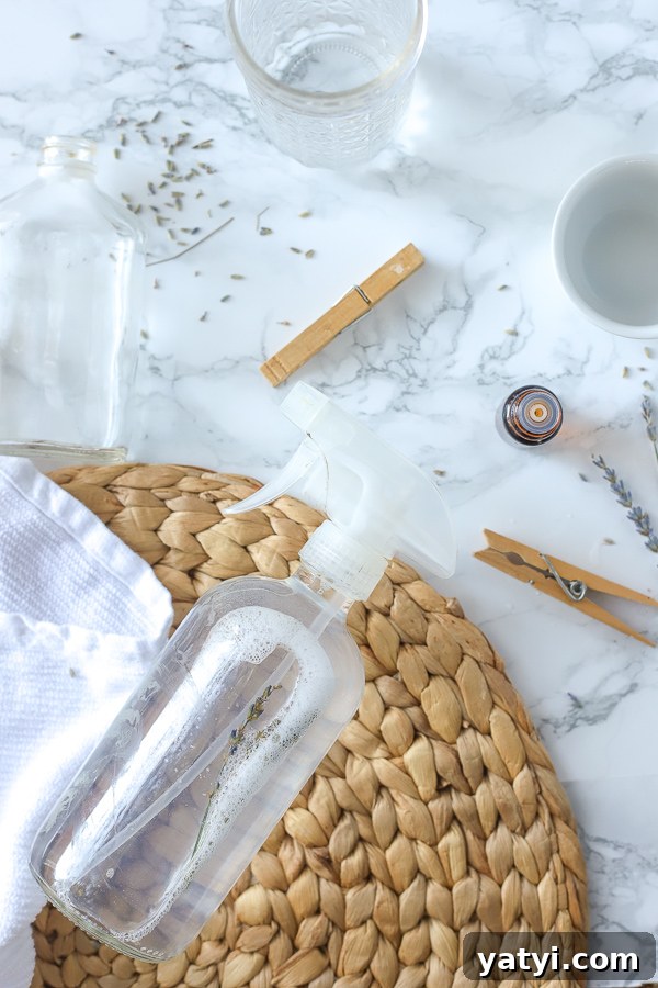 DIY All-Purpose Cleaner That Cleans Glass and Surfaces 6 DIY All-Purpose cleaner on a rattan place mat with clothes pins and essential oils around it