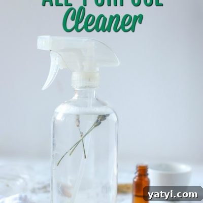 glass spray bottle of DIY all-purpose cleaner on a rattan place mat and ingredients around it
