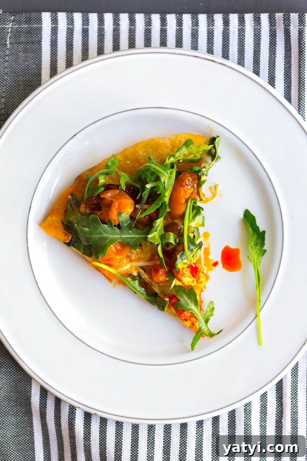 Slice of Tomato Confit Burrata and Arugula Pizza