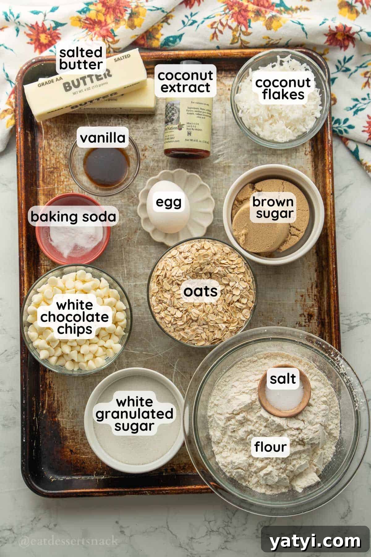 Labeled ingredients for oatmeal coconut cookies on tray.