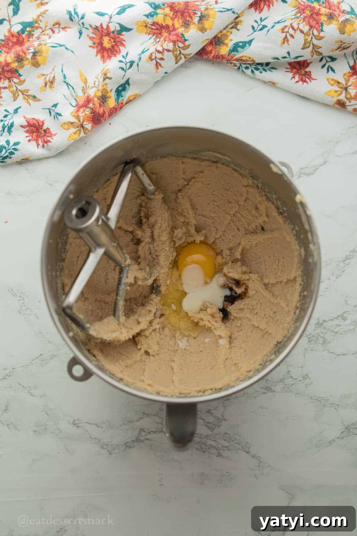 Egg and coconut extract in mixing bowl.