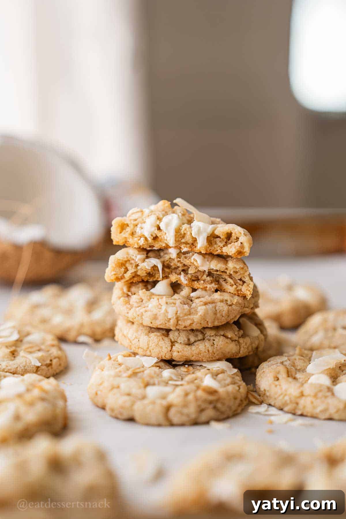 Stacked oatmeal cookies on baking tray.