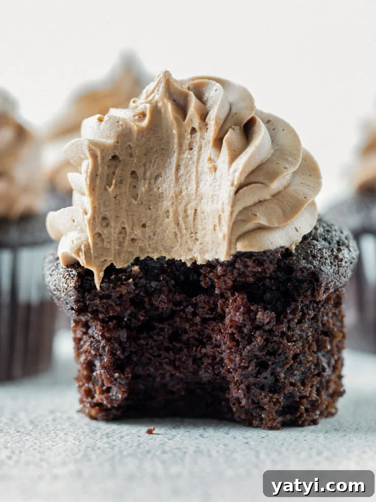 Decadent Chocolate Cupcakes: Moist, Rich Recipe for Home Bakers 2 close up shot of chocolate cupcake with a bite taken out of it