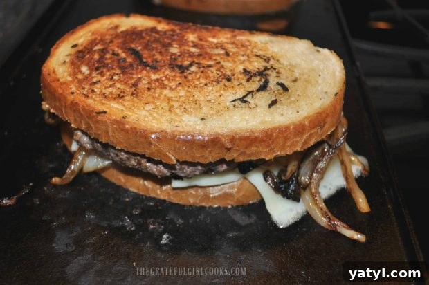 Grilled Patty Melt / The Grateful Girl Cooks! Grilled Patty Melt is flipped over to cook other side of bread on grill until golden brown.
