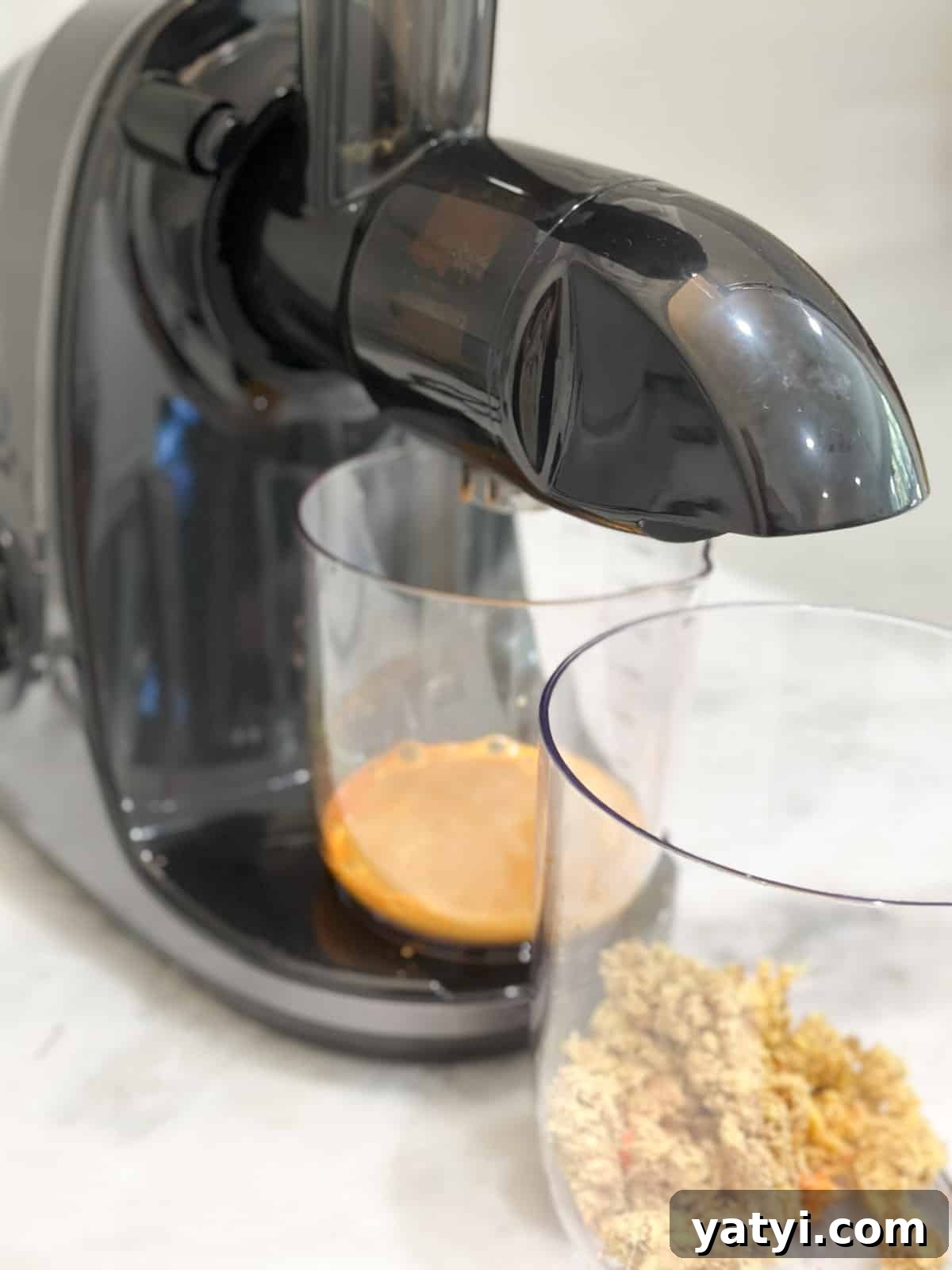 Ginger Juice Recipe: Make Fresh Ginger Juice with a Blender or Juicer 5 Ginger juice coming out of a juicer.